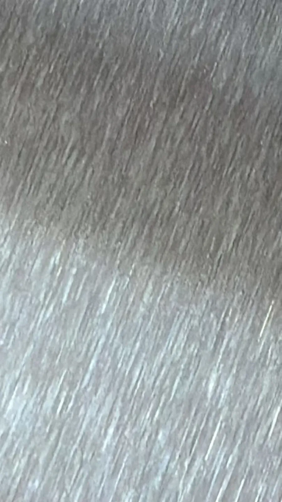 Close-up of uniform abrasive grain on aluminum coil surface